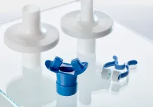 medical components are displayed on a glass table